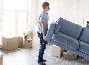 person carrying sofa